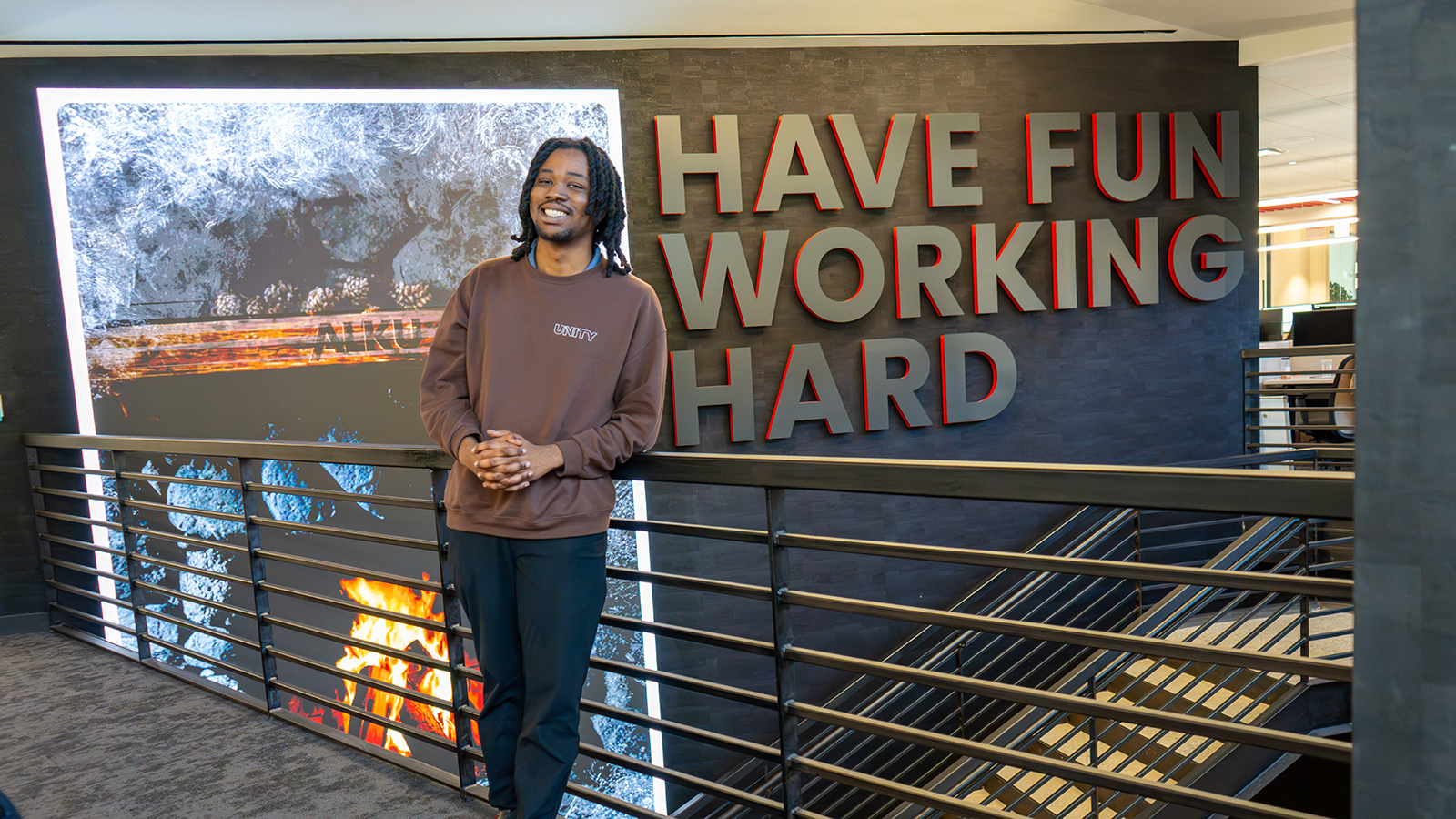 Roshaine poses in front of ALKU sign