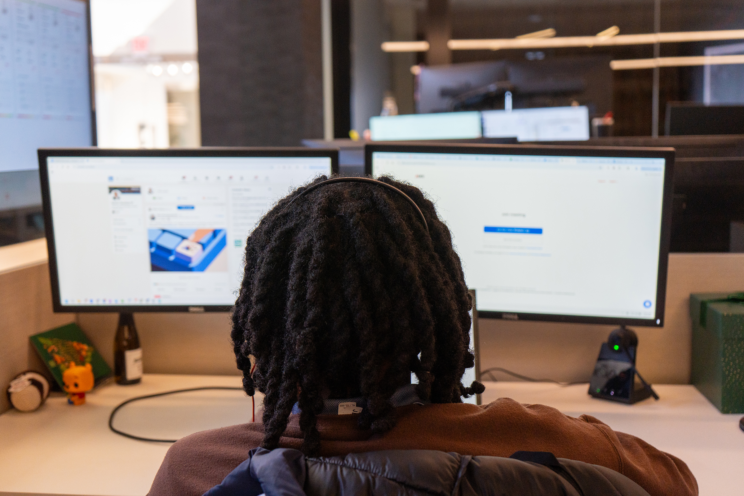 Roshaine behind two monitors