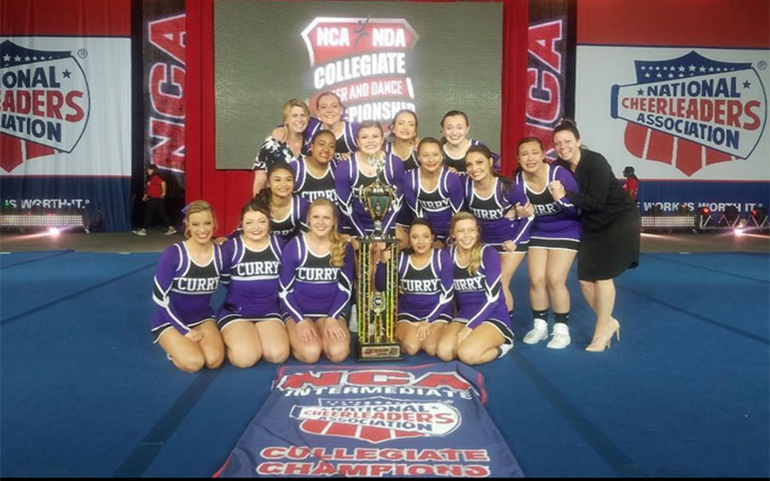Curry College Cheerleading Squad Poses for a team picture after Winnning a National Title