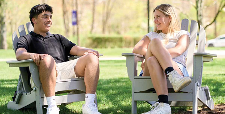 Curry Report cover - Students chatting while sitting on Adirondack chairs