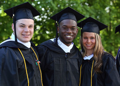 Vision in Action is the Curry College Strategic Plan 2018-2022, laser focused on student success as depicted here by three students on graduation day.