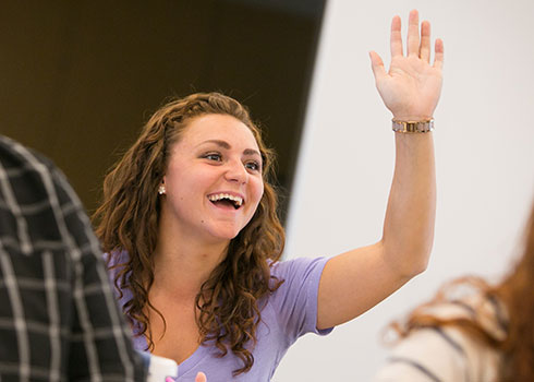A student raises her hand in class