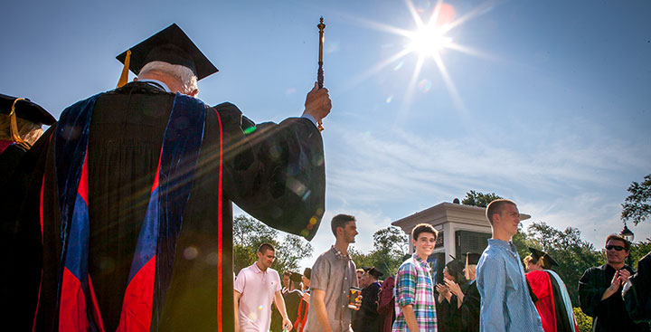 Curry College professor cheers for the incoming students at Convocation