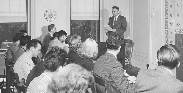 A black and white photo of a professor teaching students at the School of Expression in Boston