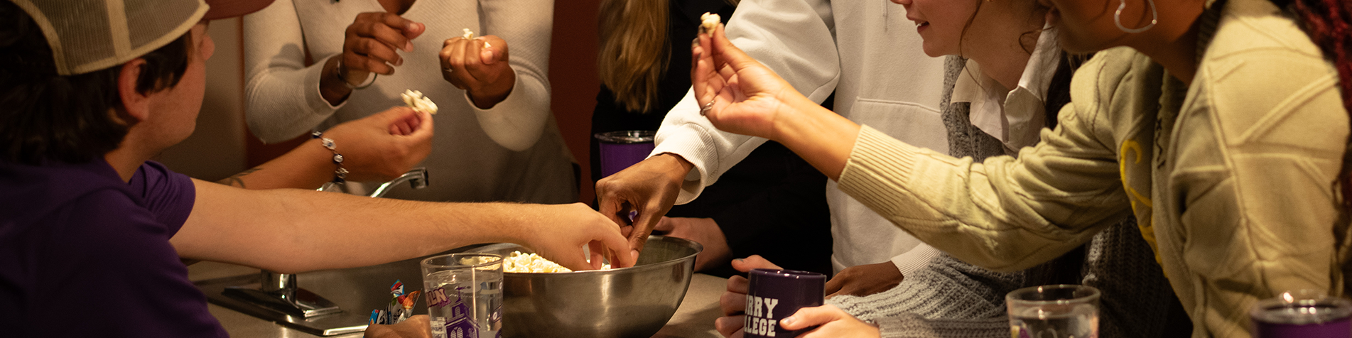 SAIL students sharing popcorn at a movie night