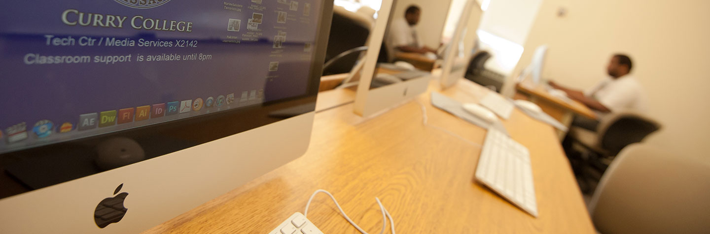 A row of Macs representing Tech Services at Curry College