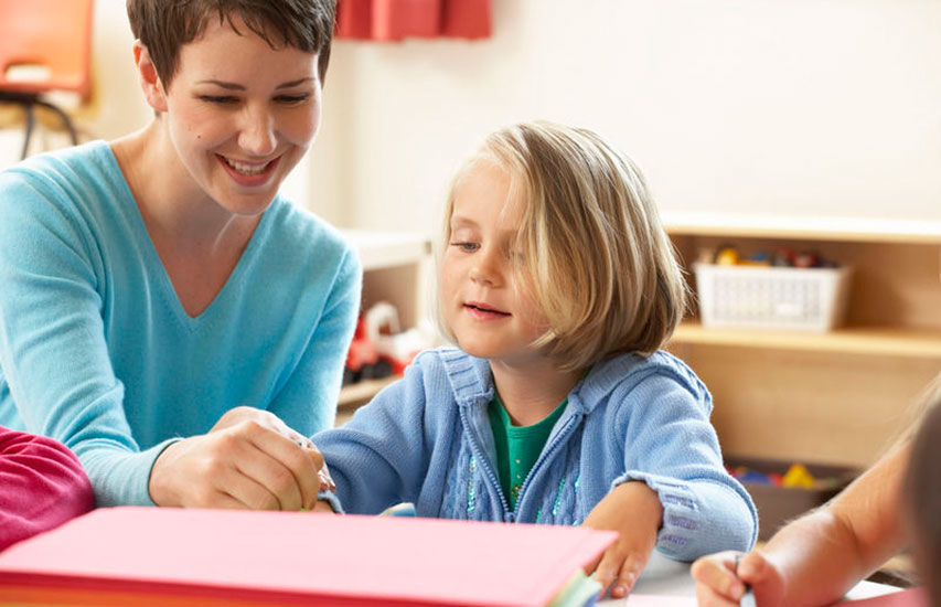 A teacher and a student representing the Autism Specialist Certificate work on an assignment