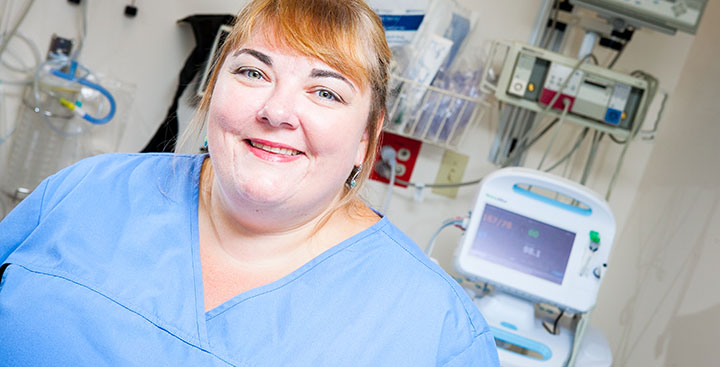 Curry College nursing alumna in scrubs