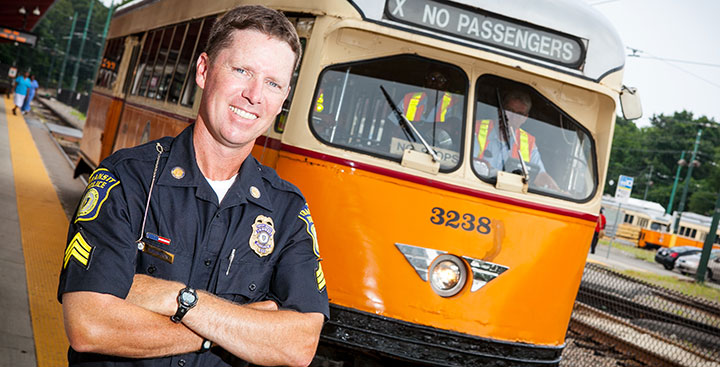 Curry College continuing education alumnus in police uniform representing the criminal justice degree program at Curry College