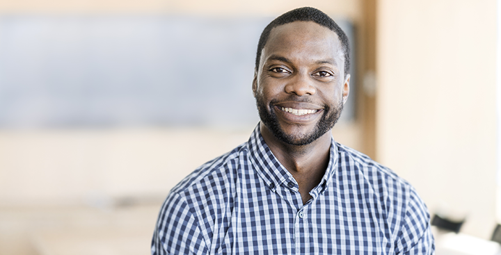 A student pursuing a Curry College Master of Science in Accounting Degree poses for a photo while smiling