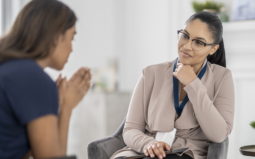 A Licensed Marriage and Family Therapist (LMFT) speaks with a client.