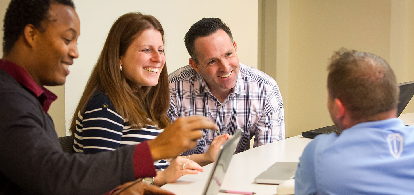 Curry Colege students pursuing a Graduate Studies Degree in class collaborating on a project