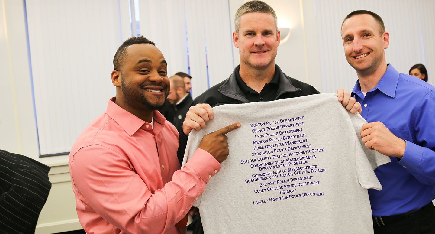 Curry College Master of Arts in Criminal Justice students pose for a picture as cohort collaborators