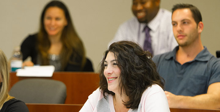 Curry College Master of Business Administration (MBA) Degree students in class smiling