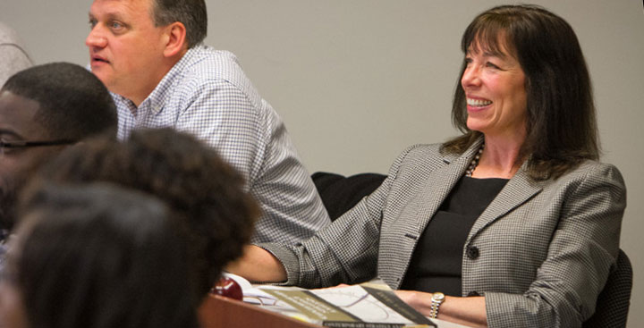 A Curry College Master of Science in Accounting student smiles in class