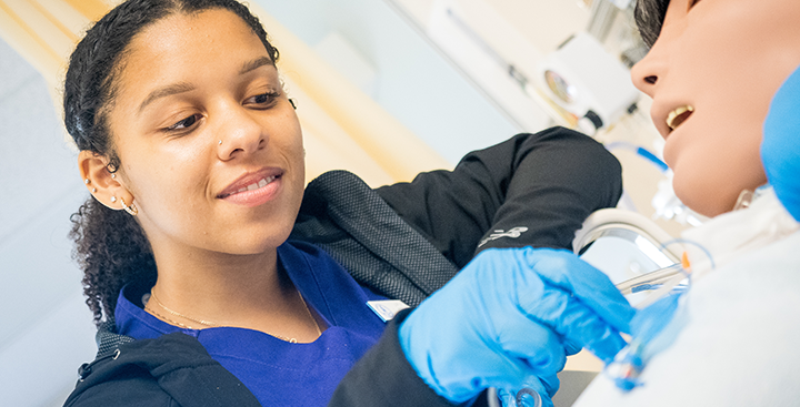 A nursing student in the SIM Lab at Curry College