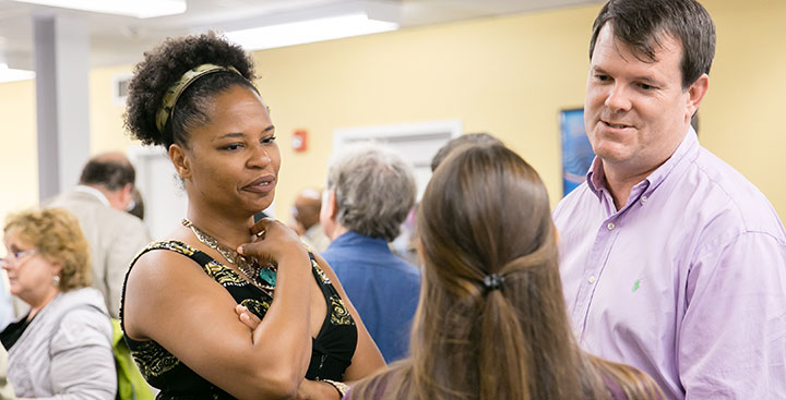 Curry College faculty members converse with a First-Year student