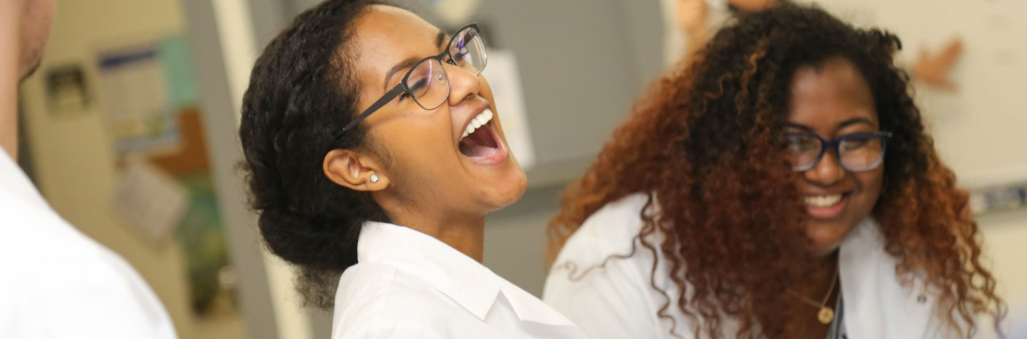 First-Year student enjoy a laugh in the classroom at Curry College