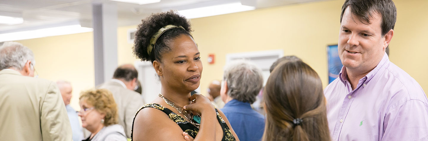 Curry College First-Year Faculty members converse with a First-Year student