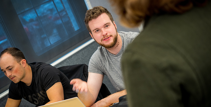 A Curry College faculty member converse with a First-Year student