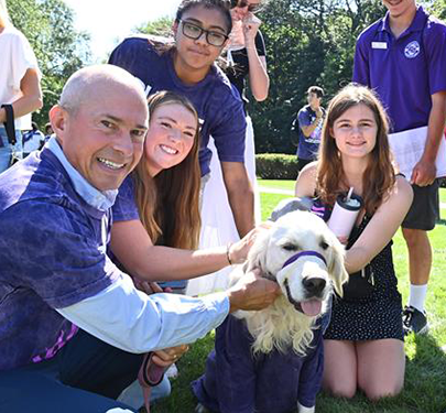 President Gonzalez and students pet Graham