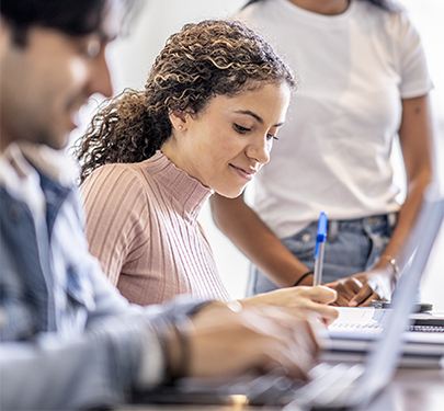 A student at a laptop receiving employment coaching