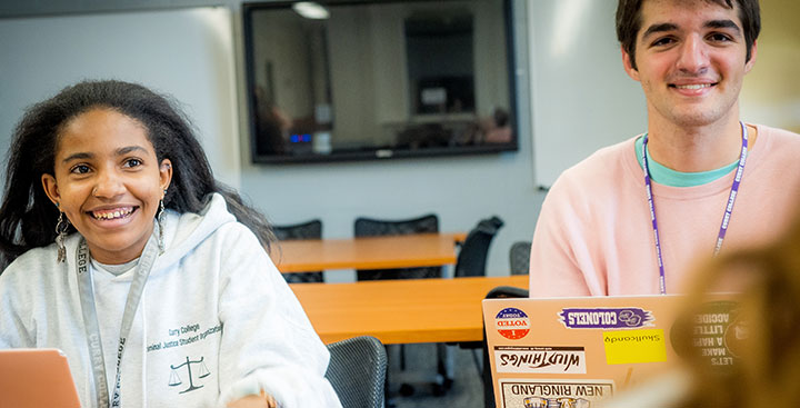 Curry College Program for Advancement of Learning (PAL) students work off a laptop together