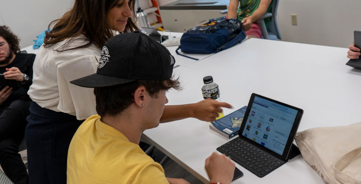 A Program for Advancement of Learning (PAL) student is assisted by a PAL faculty member