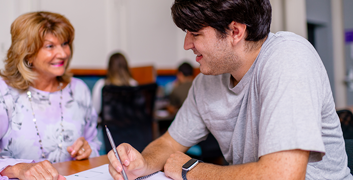 Curry College Program for Advancement of Learning (PAL) student working with his PAL faculty advisor