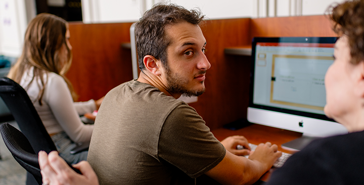 A Program for Advancement of Learning (PAL) faculty member teaching a student