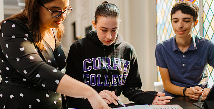 A Program for Advancement of Learning (PAL) student is assisted by a PAL faculty member