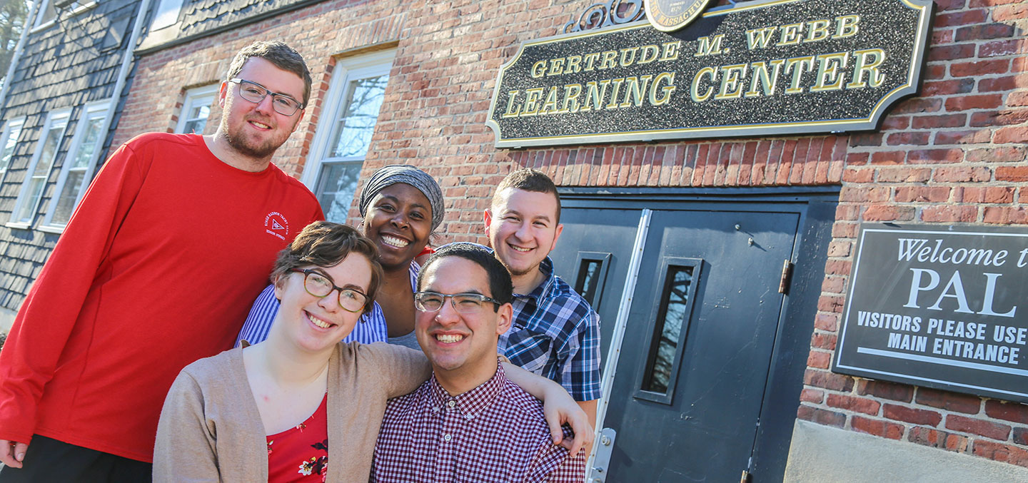 Students in the Curry College Program for Advancement of Learning (PAL) smile and pose for a photo
