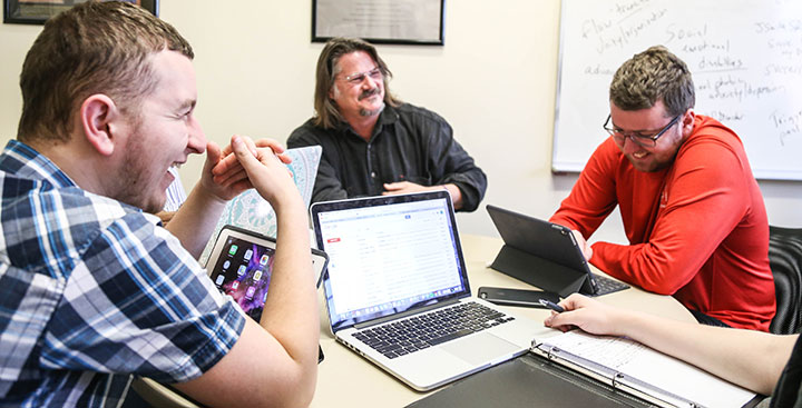 Students laugh and work on PAL Academics with their PAL professor