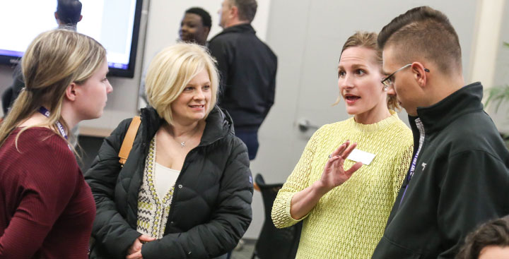 A Program for Advancement of Learning (PAL) faculty member explains the PAL program to parents of a student