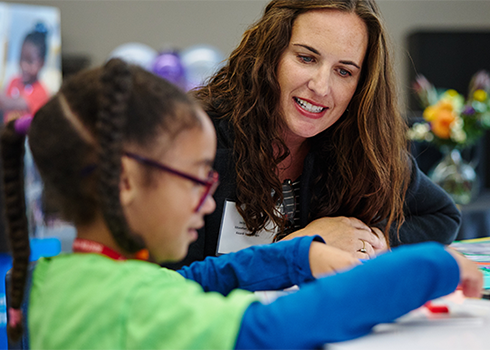 A student and teacher collaborate on a lesson through the Aicardi Early Steps Program