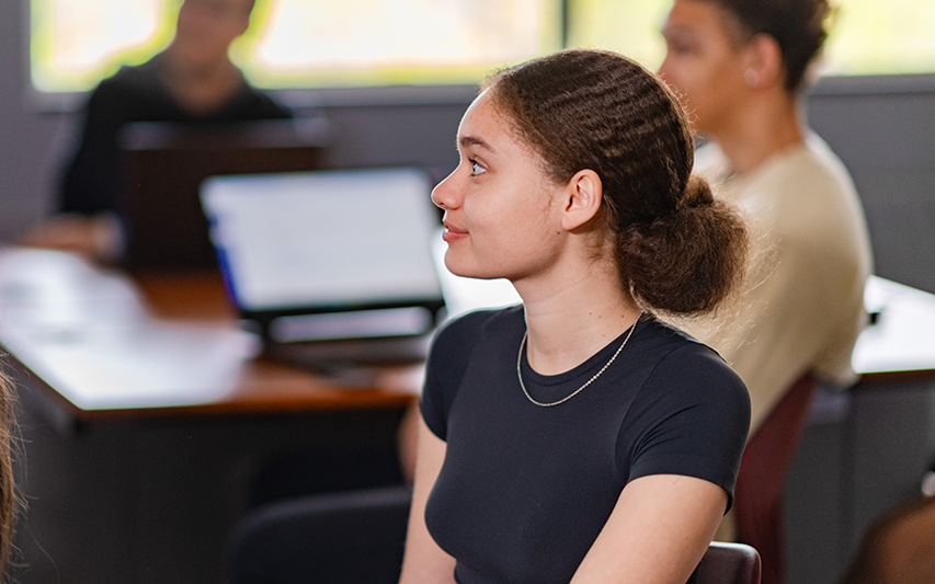 A student listens intently to her professor in class