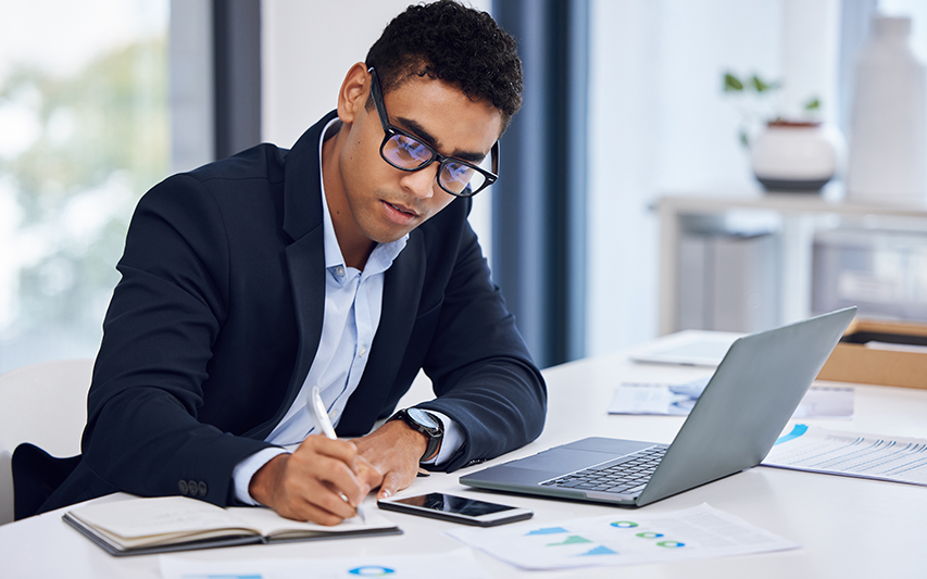 A student pursuing a 5th Year MBA at his laptop