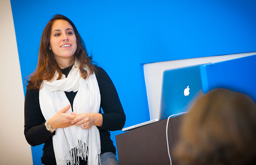 A successful alum giving a presentation represents the Entrepreneurship/Small Business concentration at Curry College