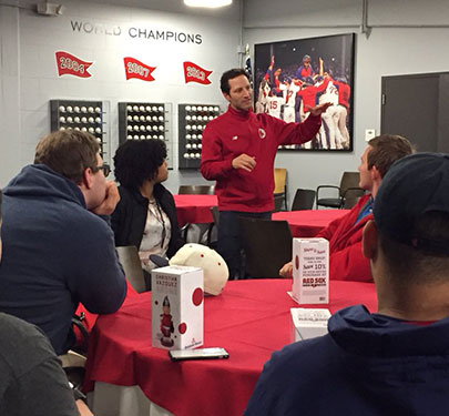 Red Sox Chief Marketing Officer Adam Grossman talks to Curry sports media students during a field trip to Fenway Park.