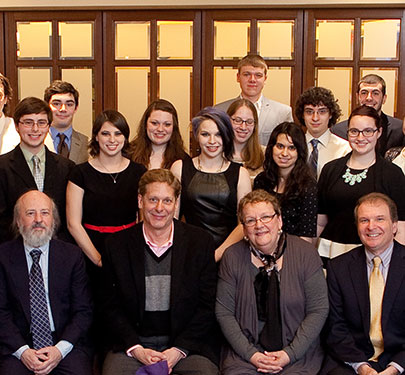 The Curry College COM Scholars and professors pose for a photo at an event