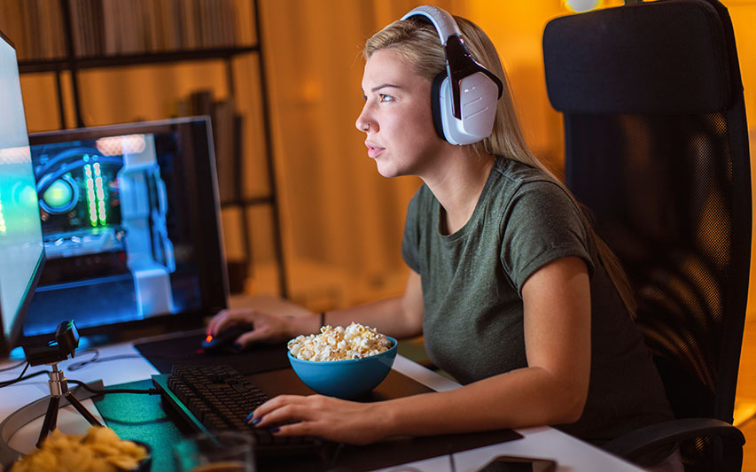 Student at a desktop gaming console representing the Video Gaming Studies minor at Curry College