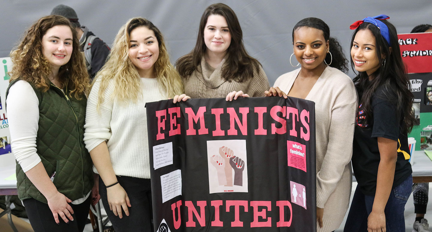 Student from the Feminists United club pose for a photo