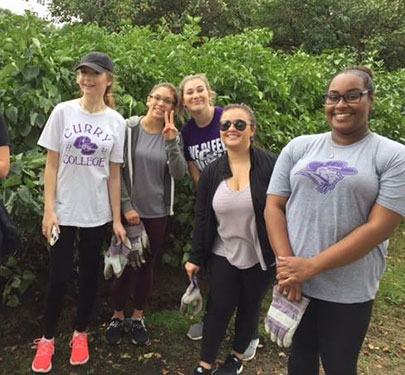 Curry College Honors students and faculty clean up the Fenway and prepare composting piles at Dorchester Community Gardens