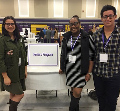 Curry College Honors students at their table set up on Accepted Student Day