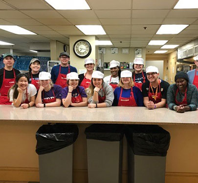 Curry College Honors students and faculty volunteer to prepare and serve meals at Rosie's Place, a Boston shelter for homeless women