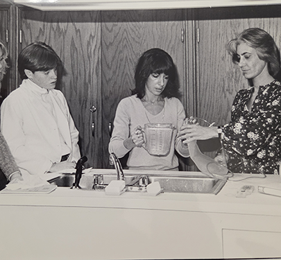 Nursing students and faculty fill an IV bag