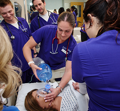 Curry Nursing student work as a team in the SIM Lab on campus