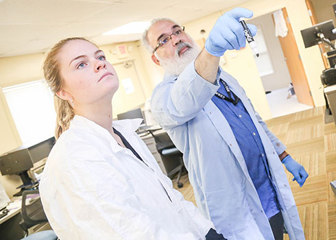 Forensic Science Professor Jim Jabbour collaborates with a Curry College student in the lab