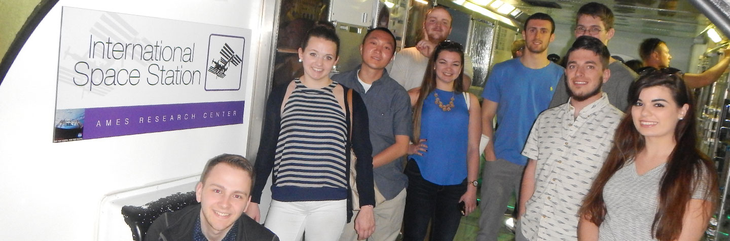Students at Curry College pursuing a Science Degree work in a lab with their professor