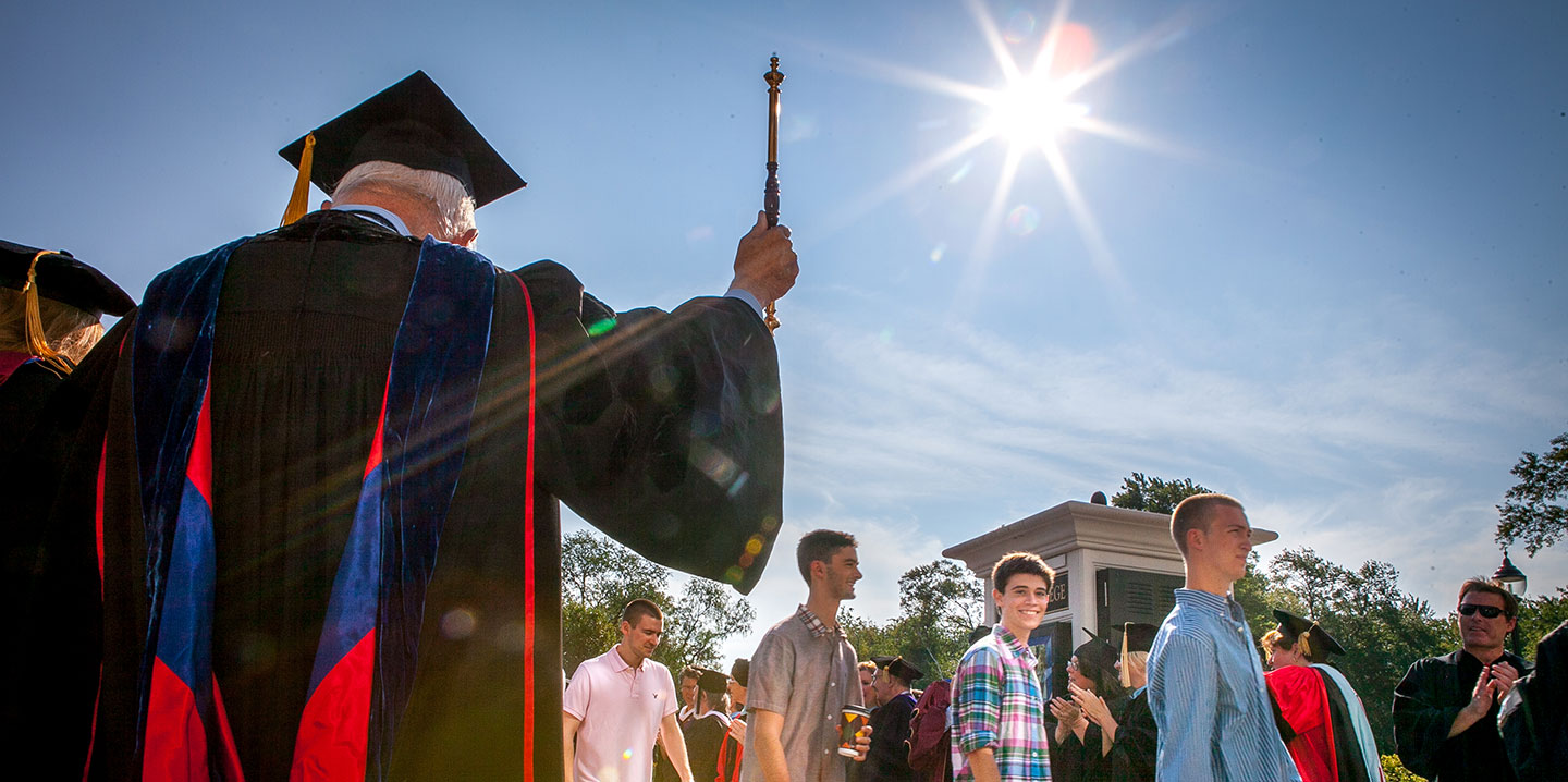 Professor cheering on student at Convocation representing Academics at Curry College